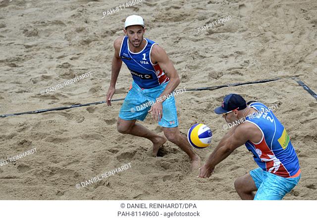 Nicholas Lucena (L) and Philip Dalhausser (R) of the USA in action against Alexander Brouwer and Robert Meeuwsen of the Netherlands during the final of the...