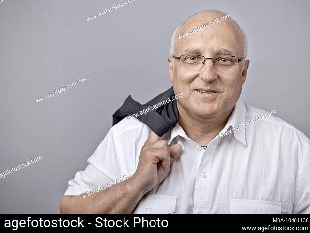 man with glasses looks at camera with a smile, portrait