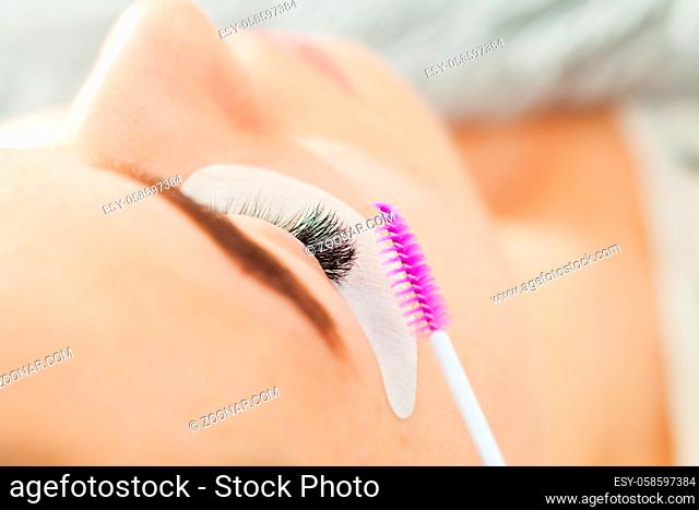Woman Eye close up during the Eyelash Extension Procedure. Macro, selective focus