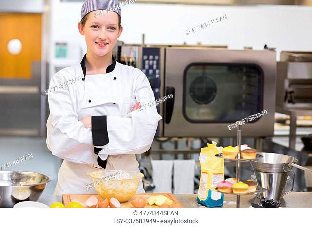 Proud baker standing at counter in kitchen