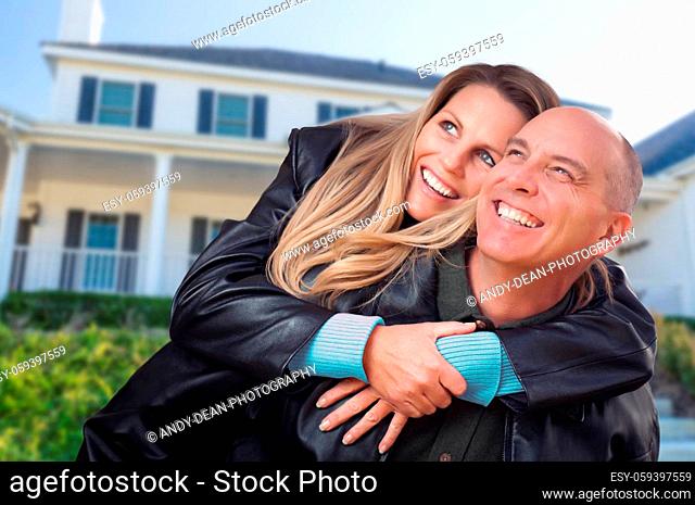 Happy Couple Hugging in Front of Beautiful House