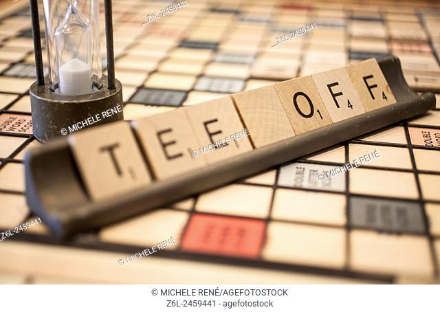Scrabble game square tiles formed to say Tee Off