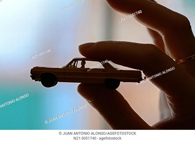 1960s Chevrolet Impala taxi model by Matchbox held by a woman's hand
