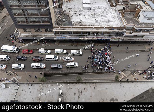 19 February 2022, South Africa, Johannesburg: A picture taken from a high-rise building shows members of ""Operation Dudula"" marching along a street in the...