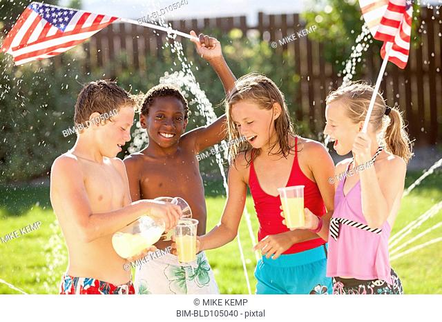 Caucasian friends drinking lemonade on Fourth of July