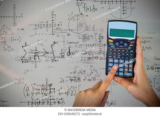 Composite image of hands of businesswoman using calculator
