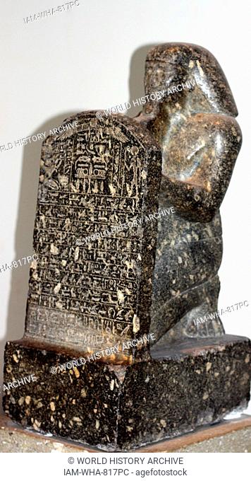 Statue of Montuemhat kneeling and holding up a stele. 25th or 26th Dynasty (approx. 670-650 BC) Egyptian. Made from Granodiorite