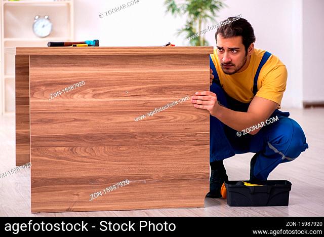 Young male carpenter working in the office