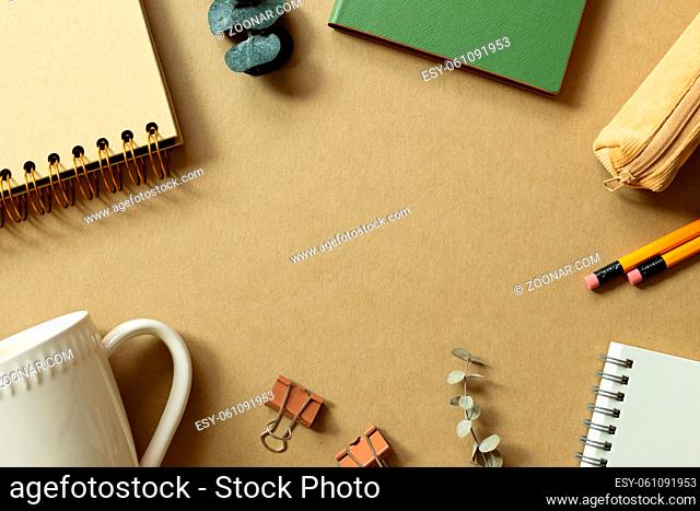 Various office supplies on brown background. workspace. flat lay, top view, copy space