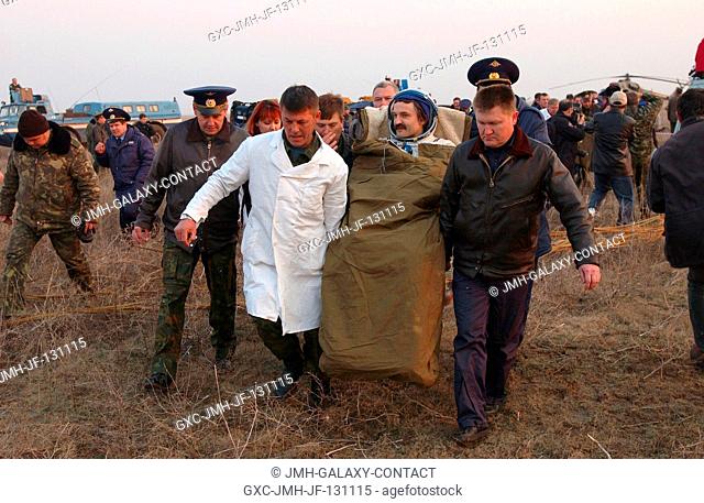 Cosmonaut Alexander Y. Kaleri, Soyuz flight engineer representing Russia's Federal Space Agency, is carried in a chair from the Soyuz landing site to an...