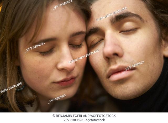 affectionate woman and man with closed eyes