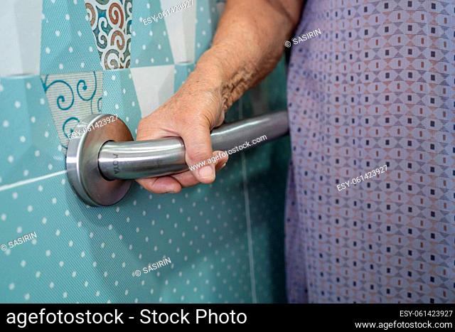 Asian senior or elderly old lady woman patient use toilet bathroom handle security in nursing hospital ward, healthy strong medical concept