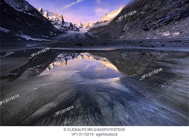 Sunrise from a pond at Forno Glacier, Forno Valley, Maloja Pass, Engadin, Graubünden, Switzerland, Europe