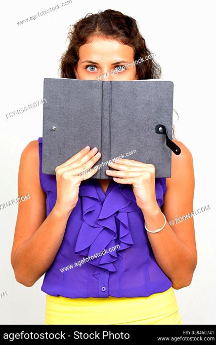 Studio shot of young beautiful businesswoman with curly hair against white background