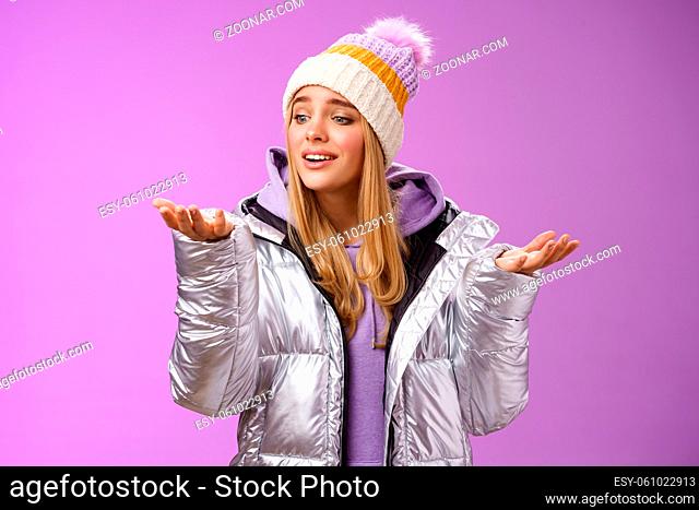 Delighted caring lovely young blond woman looking snowflake drop palm glancing hand tenderly smiling cherish nice moment enjoying winter snowy day standing...