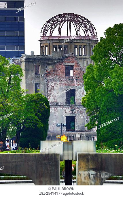 The Genbaku Domu, Atomic Bomb Dome, and the Peace Flame in the Hiroshima Peace Memorial Park, Hiroshima, Japan commemorating the bombing of Hiroshima at the end...