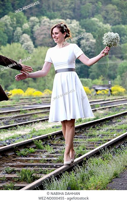 Bride balancing on rail