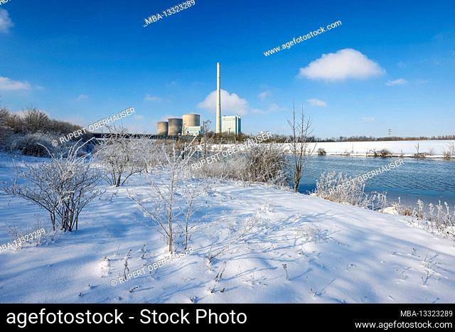 Hamm, North Rhine-Westphalia, Germany - Sunny winter landscape in the Ruhr area, ice and snow on the Lippe, in the back the RWE Gersteinwerk gas power plant