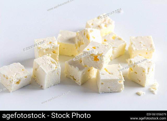 Feta cheese diced on white background