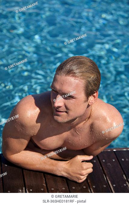 Man climbing out of swimming pool