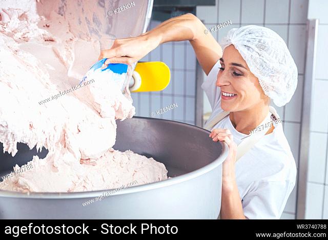 Woman working in butchery making minced meat checking quality