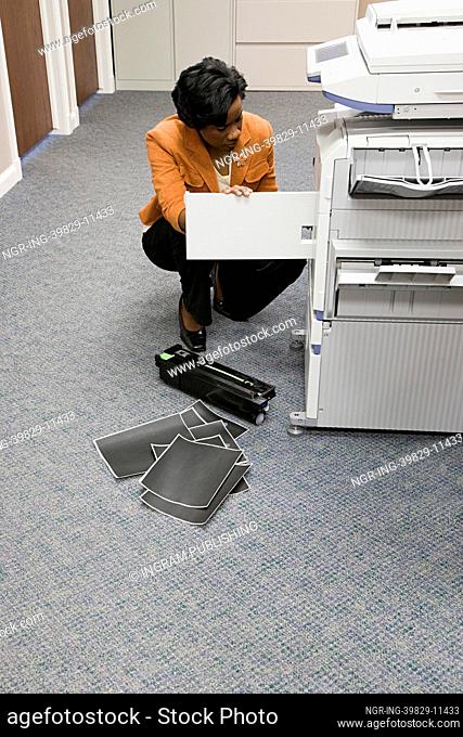 Office worker looking at photocopier