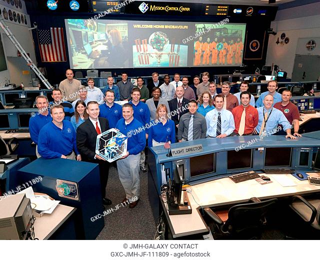 The members of the STS-130 AscentEntry flight control team and crew members pose for a group portrait in the space shuttle flight control room in the Mission...