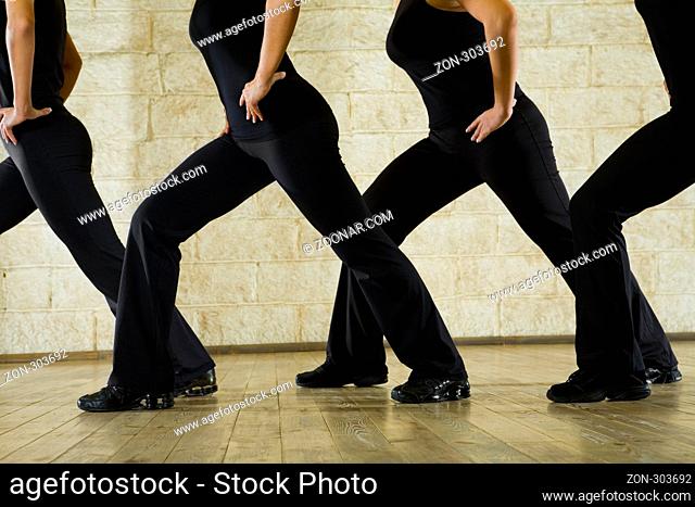 Bottom parties of the body exercising women. Side view