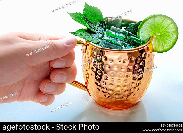 A Person Holding a Moscow Mule Mug drink on a white background