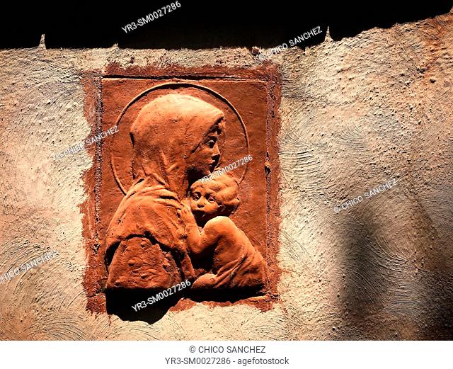 A relief of the Virgin Mary holding Jesus Christ decorates a house in Coyoacan, Mexico