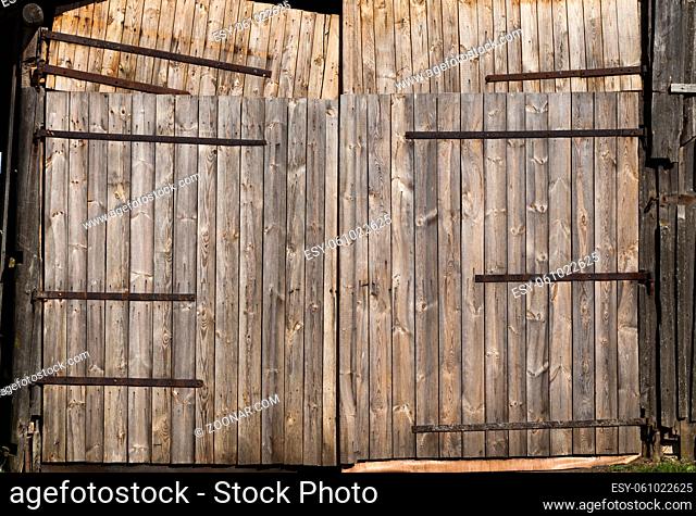 several old wooden gate in a barn in the countryside, close-up of an old rustic building