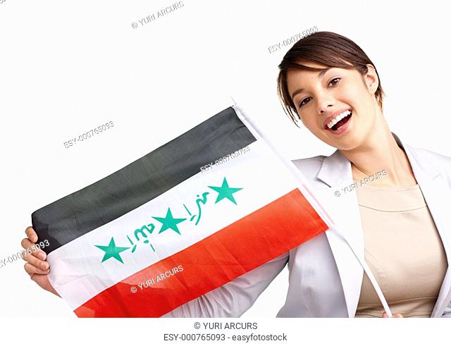 Portrait of a cute young woman displaying an Iraqi flag against white background