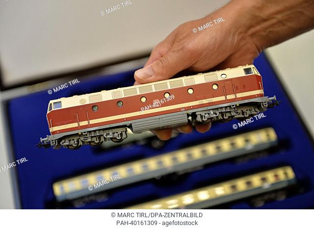 A man presents a model regional train Thuringia with a diesel locomotive BR219 180-7 of the size HO at a factory of model railroad manufacturer Piko in...