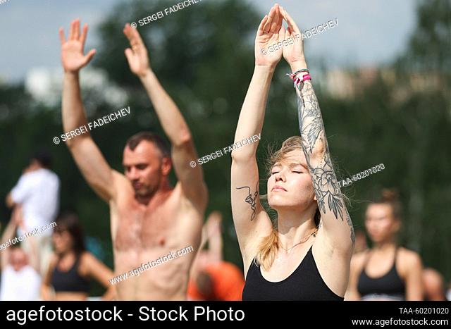 RUSSIA, MOSCOW - JULY 2, 2023: People do exercises during Yoga Day Russia 2023, a yoga festival marking the International Day of Yoga, in Tsaritsyno Park