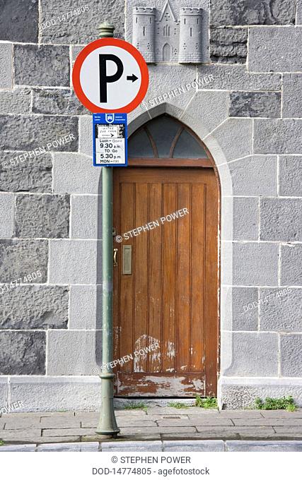 Republic of Ireland, Limerick City, parking sign in front of old wooden door