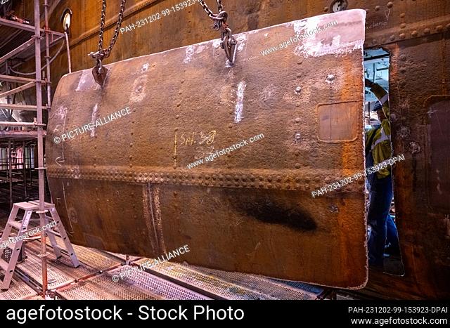 PRODUCTION - 01 December 2023, Mecklenburg-Western Pomerania, Stralsund: Workers replace a plate in the middle of the sailing ship ""Gorch Fock 1"" that was...