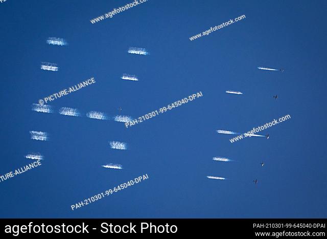 01 March 2021, Hamburg: Airplanes write an advertising message in the sky above the Reeperbahn. As part of an advertising campaign for a streaming service