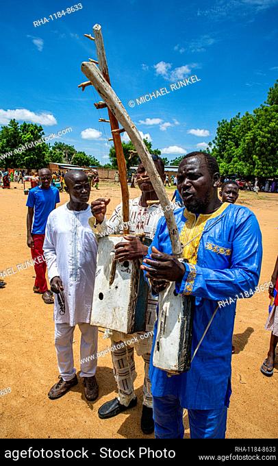 Man playing a local instrument at a tribal festival, Southern Chad, Africa