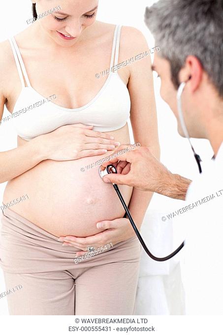 Beautiful pregnant woman and her gynecologist in his surgery