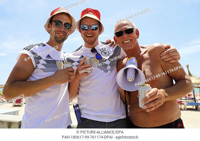 17 June 2018, Spain, Palma de Mallorca: German fans David, Nico and Thomas ready to cheer the German team before the soccer World Cup game between Germany and...