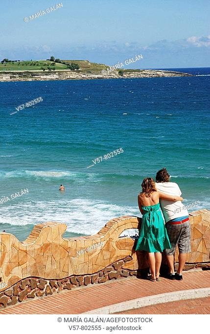 Young couple looking at the sea from a viewpoint, Piquío gardens. Santander, Cantabria province, Spain
