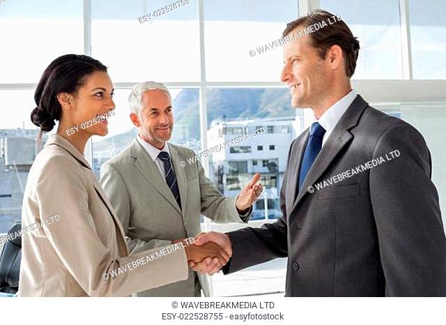 Businessman introducing a colleague to another businessman