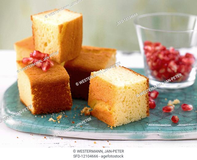 Lime cake cubes with yogurt and pomegranate seeds