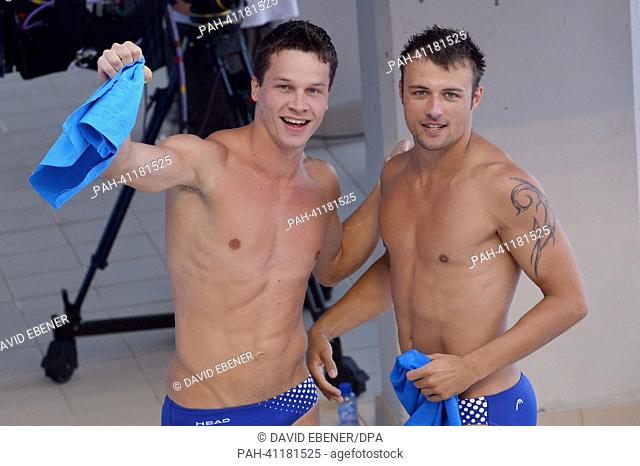 Gold medalists Patrick Hausding (L) and Sascha Klein of Germany celebrate after winning the men's 10m Synchro Platform diving final of the 15th FINA Swimming...