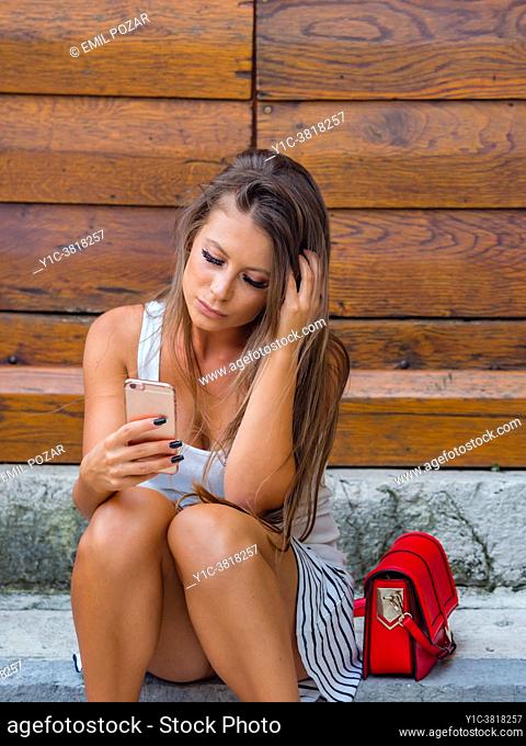 Young woman expecting message concerned