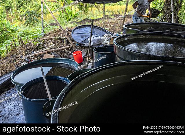 12 May 2023, Colombia, Llorente: Canisters containing, among other things, kerosene and sulfuric acid can be seen in a ""laboratory"" where coca leaves are...