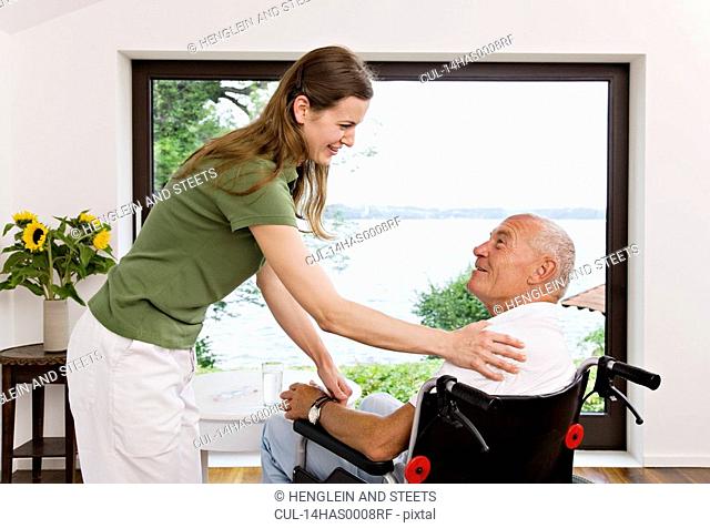 woman touching man in wheelchair