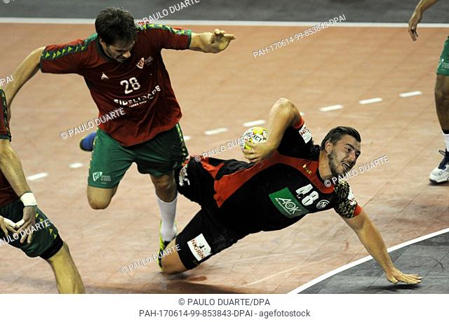 GermanyÂ·s Jannik Kohlbacher, right, tries to shoot past PortugalÂ·s Jorge Silva during the Euro 2018 Qualification Group 5 handball match between Portugal and...