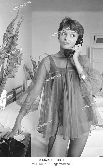 Austrian actress Nadja Tiller speaking over the phone in night gown during the 19th Venice International Film Festival. Venice, August 1958
