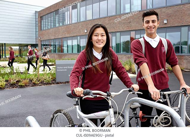 Teenager friends with cycles outside school
